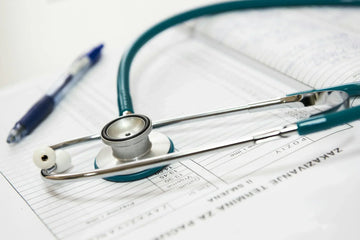 a stethoscope and pen on table